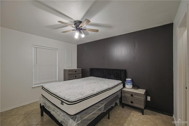 bedroom with ceiling fan and light tile patterned flooring