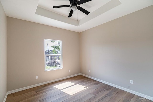 6608 Primavera St, Pharr, TX 78577 - unfurnished room featuring a tray ceiling, wood finished floors, baseboards, and a ceiling fan