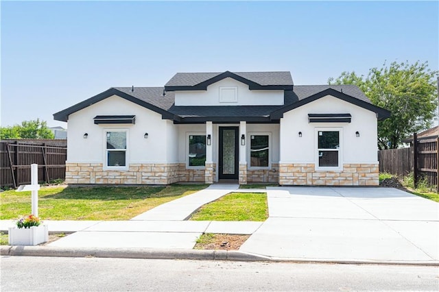 6608 Primavera St, Pharr, TX 78577 - modern farmhouse with stone siding, stucco siding, a shingled roof, covered porch, and driveway