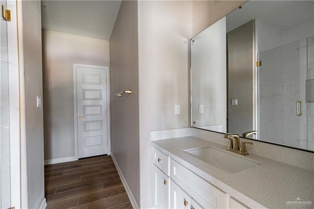 6608 Primavera St, Pharr, TX 78577 - full bathroom featuring wood finished floors, a marble finish shower, baseboards, and vanity