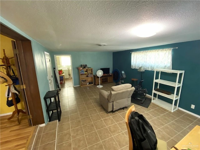 1005 Bryce Dr, Mission, TX 78572 - living area with a textured ceiling, tile patterned floors, and baseboards