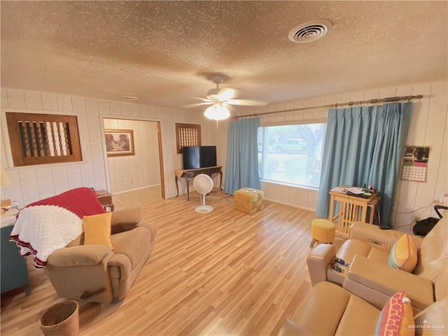 1005 Bryce Dr, Mission, TX 78572 - living room with wood finished floors, a textured ceiling, and a ceiling fan