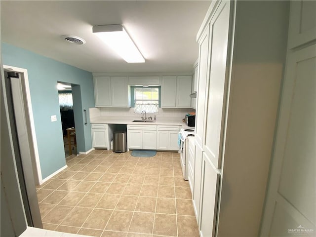 1005 Bryce Dr, Mission, TX 78572 - kitchen with a sink, white electric range oven, light countertops, backsplash, and light tile patterned floors
