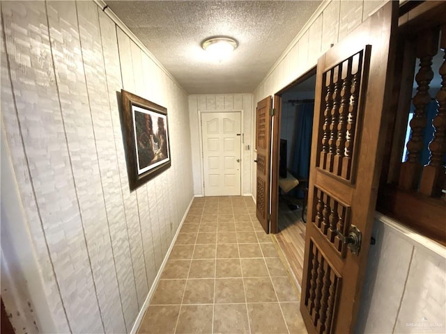 1005 Bryce Dr, Mission, TX 78572 - corridor featuring a textured ceiling, light tile patterned floors, baseboards, and crown molding