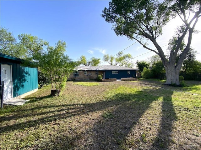 1005 Bryce Dr, Mission, TX 78572 - view of green lawn featuring an outdoor structure