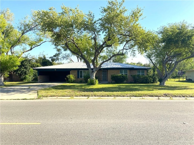 1005 Bryce Dr, Mission, TX 78572 - ranch-style home featuring concrete driveway, a carport, a front yard, and metal roof