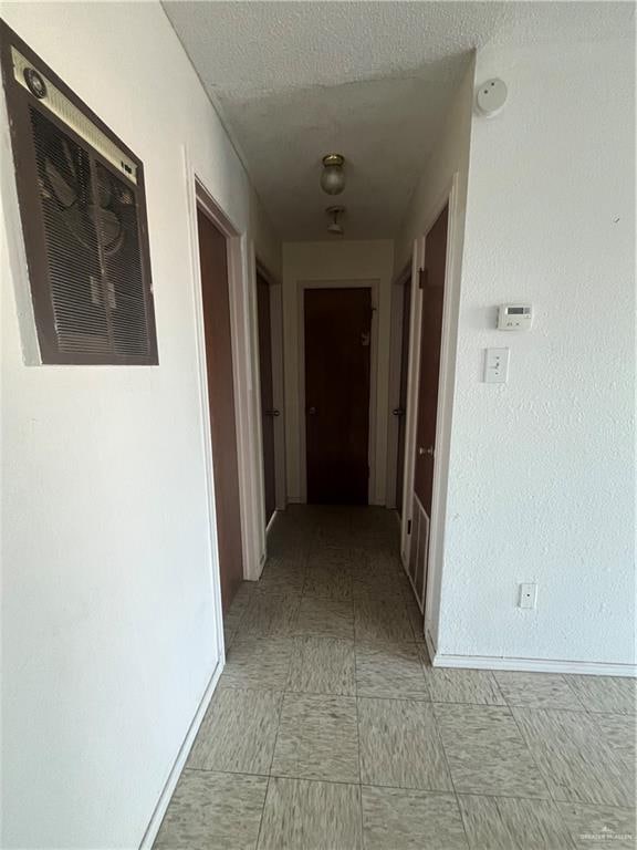 hallway featuring a textured ceiling