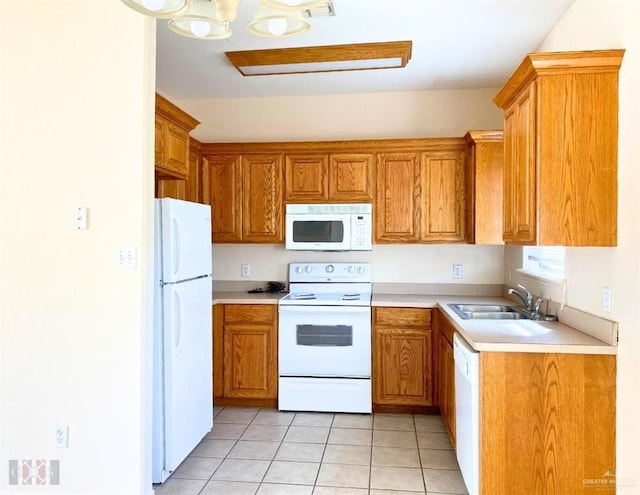 kitchen with light tile patterned floors, white appliances, and sink