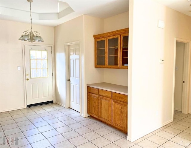 kitchen featuring light tile patterned floors, decorative light fixtures, and a notable chandelier