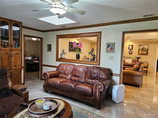 living area featuring crown molding, ceiling fan, visible vents, and marble finish floor
