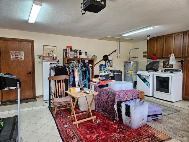 garage featuring separate washer and dryer, a garage door opener, and water heater