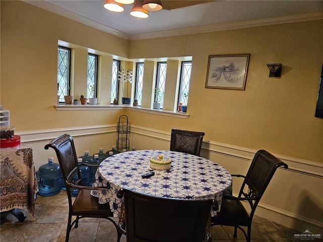 dining space featuring crown molding, an inviting chandelier, and plenty of natural light