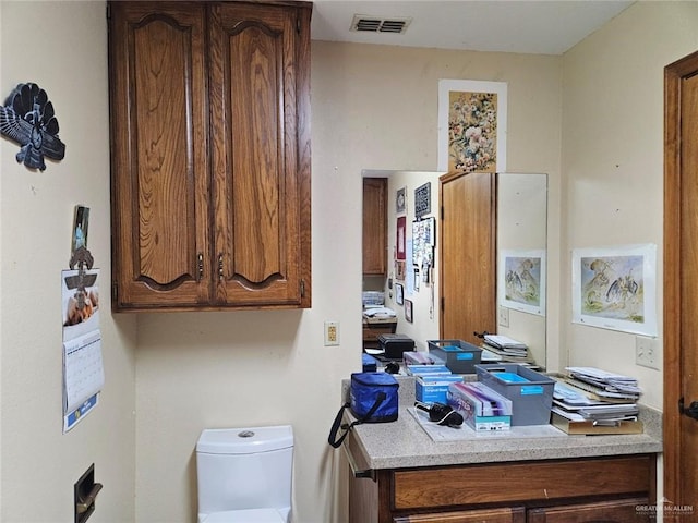 half bath featuring toilet and visible vents
