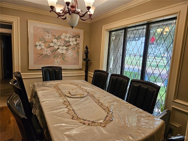 dining room with crown molding and a chandelier