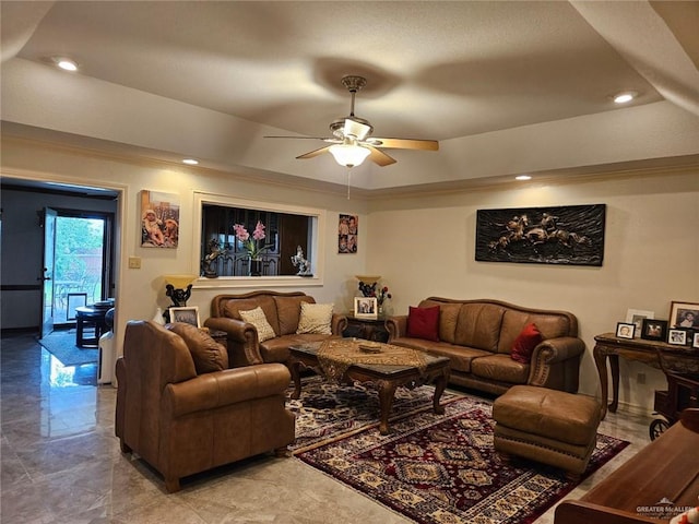 living area with a ceiling fan, a tray ceiling, recessed lighting, and marble finish floor