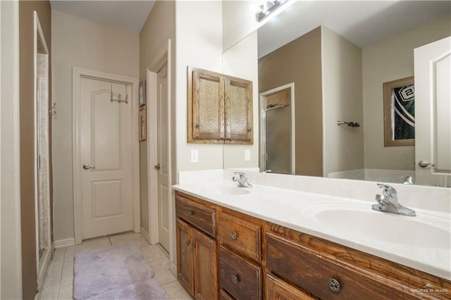 bathroom featuring tile patterned flooring, vanity, and a shower with door