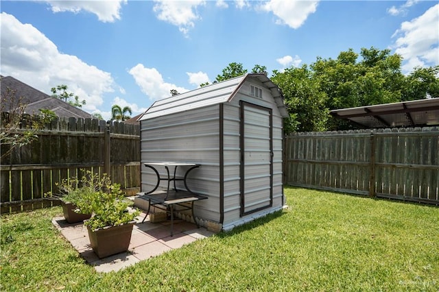 view of outbuilding with a lawn