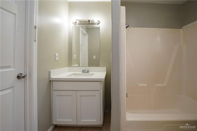 bathroom with vanity, tub / shower combination, and tile patterned floors