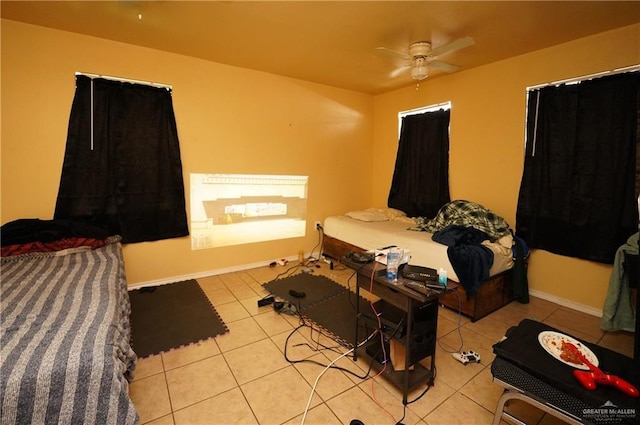 tiled bedroom with ceiling fan