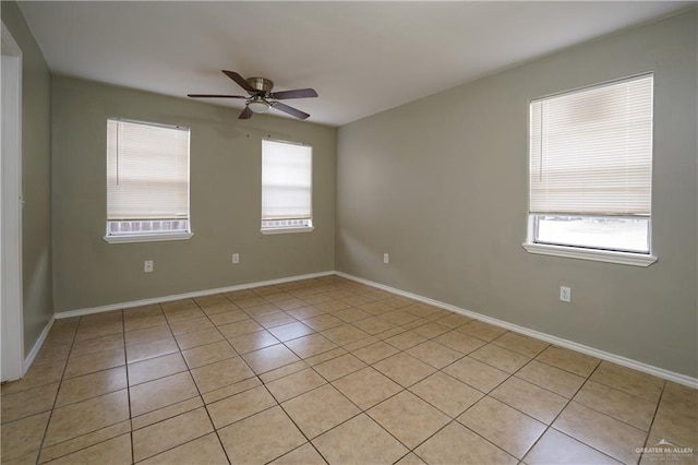 empty room with ceiling fan and light tile patterned flooring