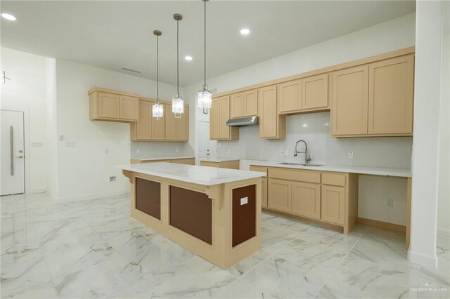 kitchen featuring a sink, under cabinet range hood, light brown cabinets, marble finish floor, and recessed lighting