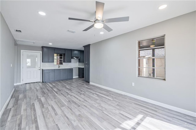 406 N Fairgrounds Rd, Rio Grande City, TX 78582 - unfurnished living room with a ceiling fan, baseboards, light wood-type flooring, and recessed lighting