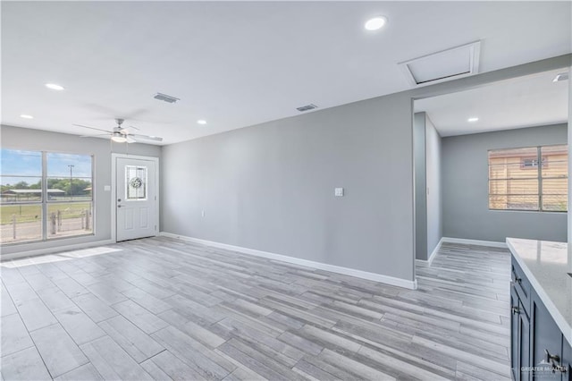 406 N Fairgrounds Rd, Rio Grande City, TX 78582 - unfurnished living room featuring baseboards, attic access, light wood-type flooring, healthy amount of natural light, and recessed lighting