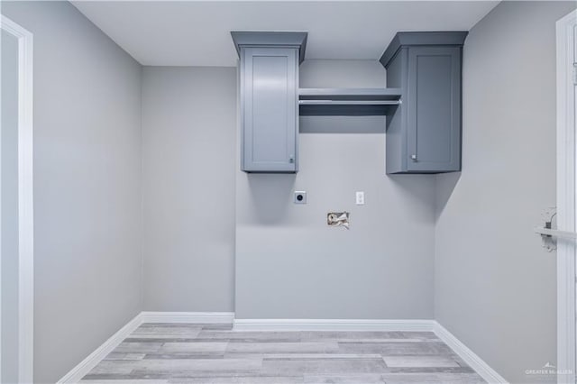 406 N Fairgrounds Rd, Rio Grande City, TX 78582 - laundry area featuring electric dryer hookup, light wood finished floors, and baseboards