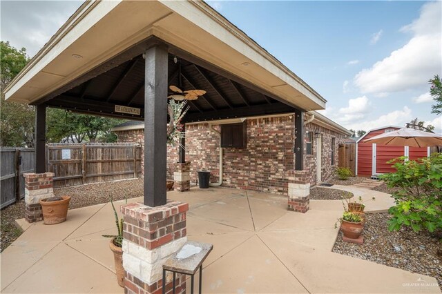 view of patio featuring a gazebo and a storage shed