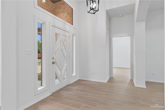 2605 Jeff St, Harlingen, TX 78550 - entrance foyer featuring baseboards, light wood-style floors, and a chandelier