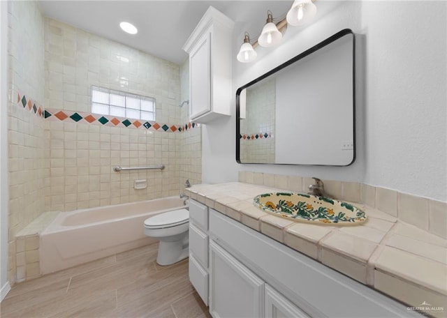 2605 Jeff St, Harlingen, TX 78550 - bathroom with vanity, toilet, shower / tub combination, wood finished floors, and recessed lighting
