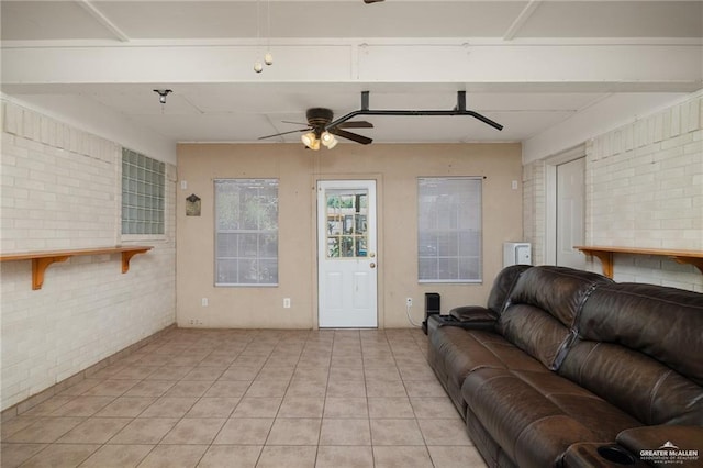 2008 Mesquite St, Edinburg, TX 78539 - living area featuring brick wall, a ceiling fan, and light tile patterned floors