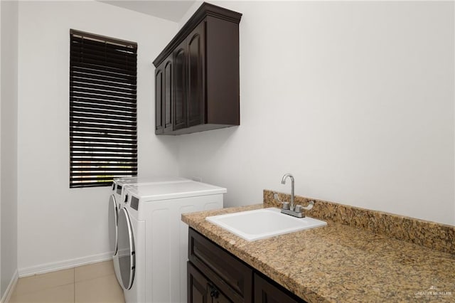 laundry area with cabinets, independent washer and dryer, light tile patterned flooring, and sink