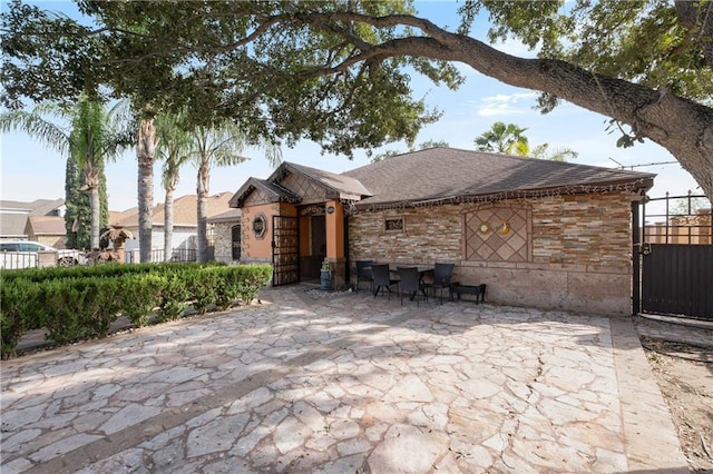 single story home with fence and a patio