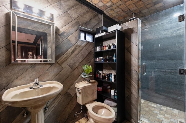 bathroom featuring a stall shower and toilet