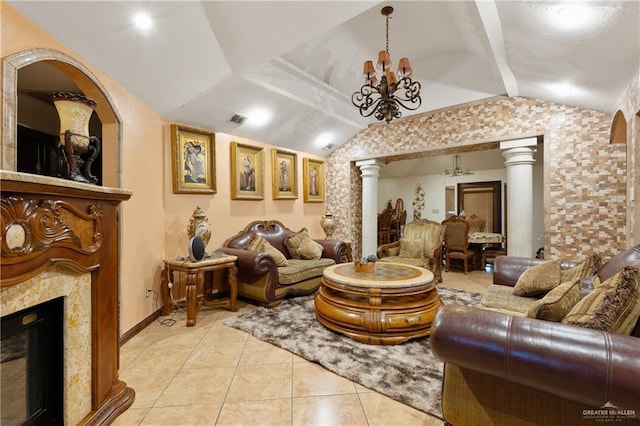 living area featuring a notable chandelier, lofted ceiling, visible vents, a high end fireplace, and ornate columns