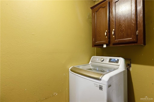 laundry area featuring washer / clothes dryer and cabinet space