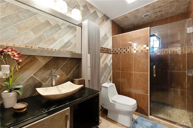 full bathroom with tile walls, backsplash, toilet, a stall shower, and vanity