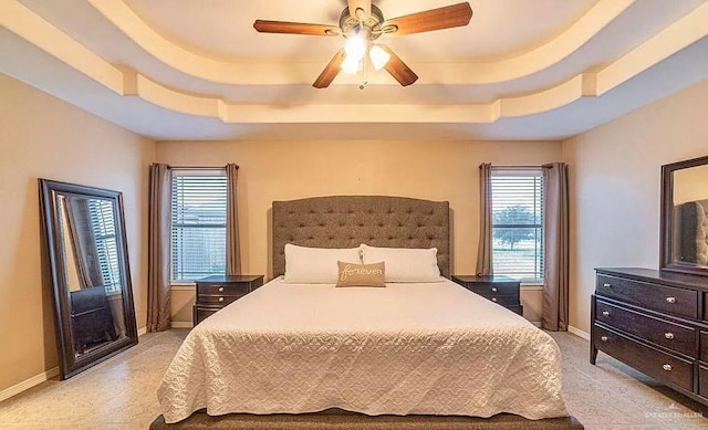 3104 Cactus Dr, Weslaco, TX 78599 - bedroom with a tray ceiling, multiple windows, and baseboards