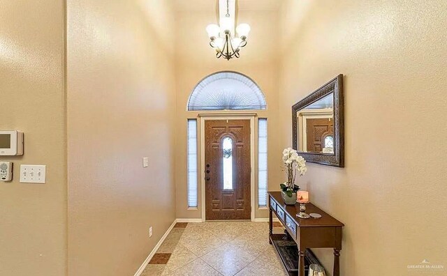 3104 Cactus Dr, Weslaco, TX 78599 - entrance foyer with a chandelier, a high ceiling, and baseboards