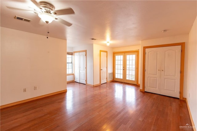3008 W 45th St, Mission, TX 78574 - spare room featuring ceiling fan, wood finished floors, french doors, and baseboards