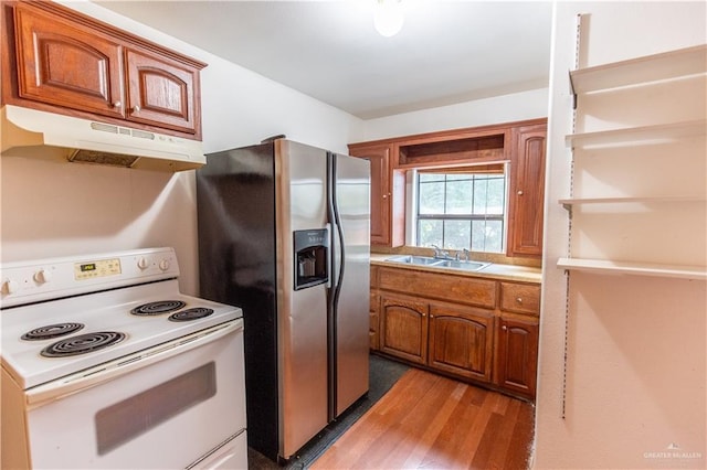 3008 W 45th St, Mission, TX 78574 - kitchen featuring electric range, under cabinet range hood, a sink, wood finished floors, and stainless steel fridge with ice dispenser