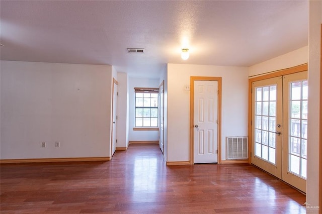3008 W 45th St, Mission, TX 78574 - spare room with french doors, wood finished floors, and baseboards