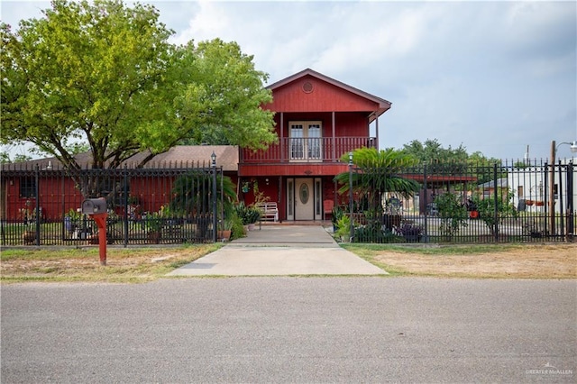 3008 W 45th St, Mission, TX 78574 - view of front of house featuring a balcony and a fenced front yard