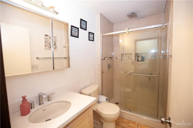 3008 W 45th St, Mission, TX 78574 - full bath featuring toilet, a stall shower, vanity, and a textured ceiling