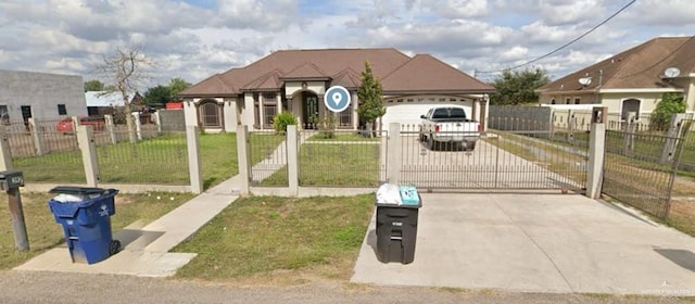 view of front of property with a garage and a front lawn