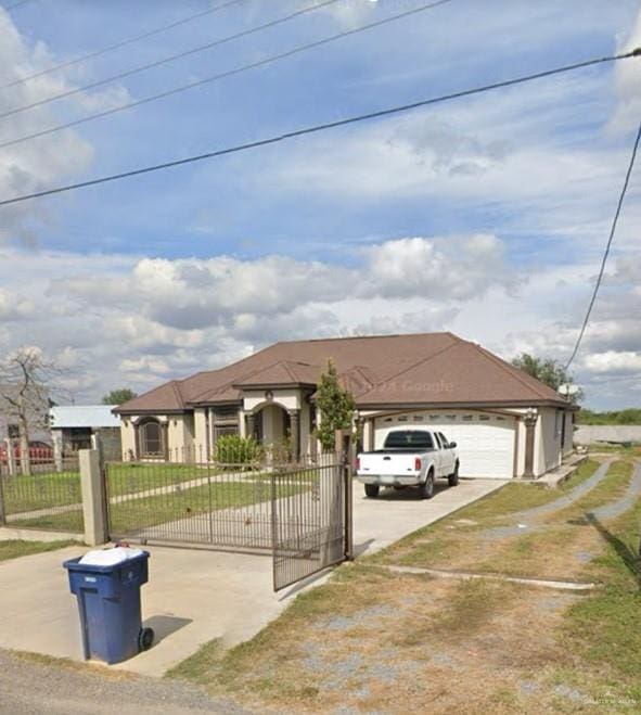 single story home featuring a front yard and a garage