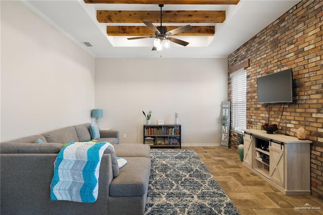 living room featuring ceiling fan, beam ceiling, and brick wall