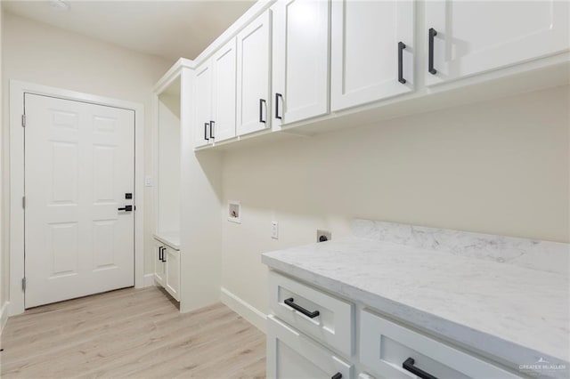 laundry area featuring hookup for an electric dryer, cabinets, light hardwood / wood-style floors, and washer hookup