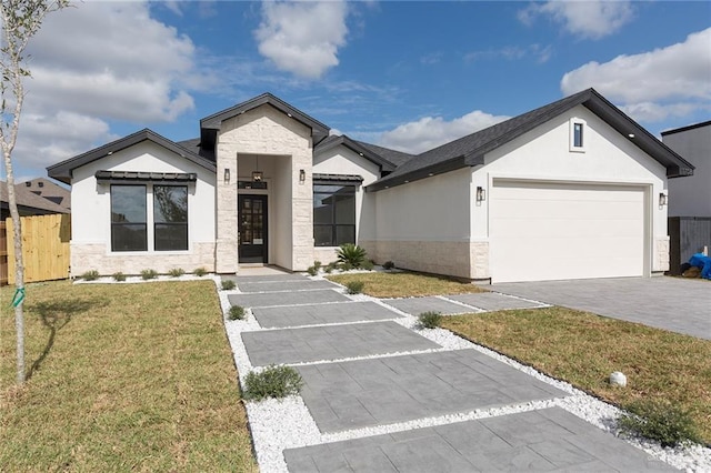 view of front of property with a front yard and a garage